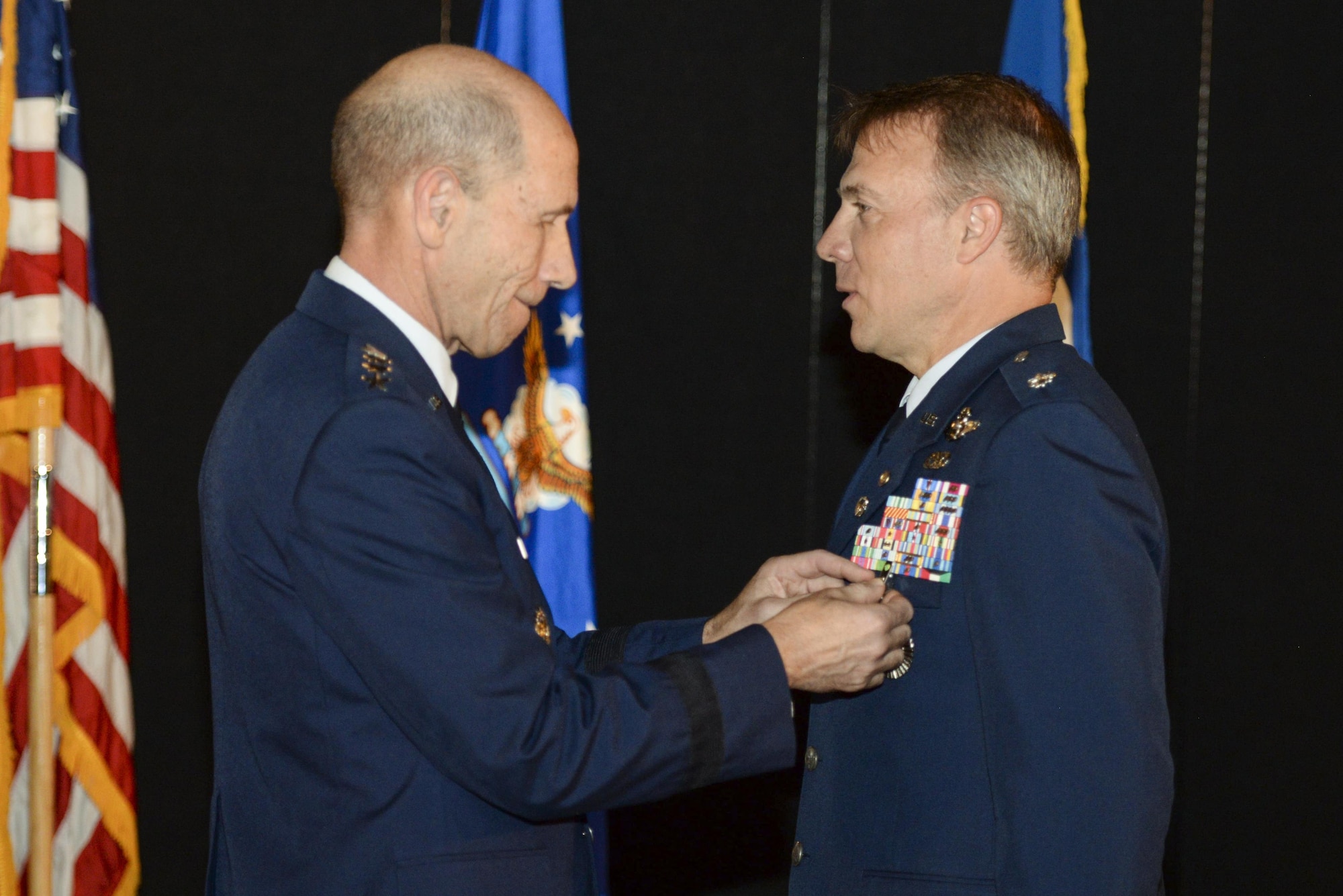 Gen. Mike Holmes, commander, Air Combat Command, presents retired Air Force Lt. Col. Gregory Thornton with the Silver Star medal during a ceremony at the National Museum of the United States Air Force in Dayton, Ohio, June 30, 2017. Thornton received the Silver Star for his actions on April 6, 2003 while supporting ‘Advance 33,’ the call sign for a ground forward air controller attached to Task Force 2nd Battalion, 69th Armor, during combat operations in Iraq. The Silver Star is the third-highest combat decoration for gallantry in action that can be awarded to a member of the United States Armed Forces. (U.S. Air Force photo by Wesley Farnsworth) 