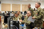 Capt. Patrick Bagley, center, is serving as the Chief of Operations (CHOPS) during the KFOR 23 validation exercise at Hohenfels Training Area, Germany. First Lt. Brian Bell, right, is a battle captain. Maj. Leslie Palmer, behind Bagley, is the deputy commander.