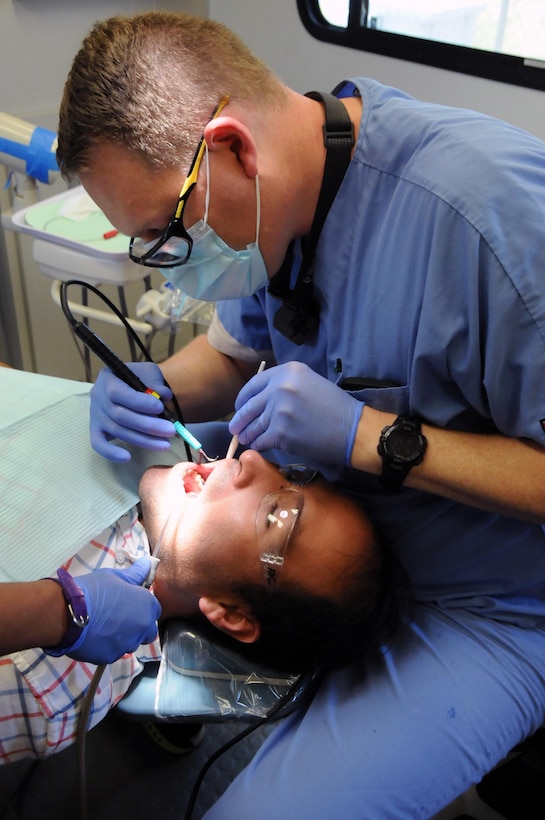 Maj. Matthew Morris, a dentist assigned to 7226th Medical Support Unit located in Fort Jackson, South Carolina, provides dental care for El Cenizo Mayor, Raul L. Reyes, at El Cenizo community center.  Morris is one of approximately 125 U.S. Army Reserve Soldiers who are working in partnership with the Texas A&M Colonias program to provide medical care to Webb County’s under-served Colonias population. Services provided by Army Reserve personnel are done through the Department of Defense’s Innovative Readiness Training, a civil-military program that builds mutually beneficial partnerships between U.S. communities and the DoD. The missions selected meet training and readiness requirements for Army Reserve service members while integrating them as a joint and whole-of-society team to serve our American citizens.