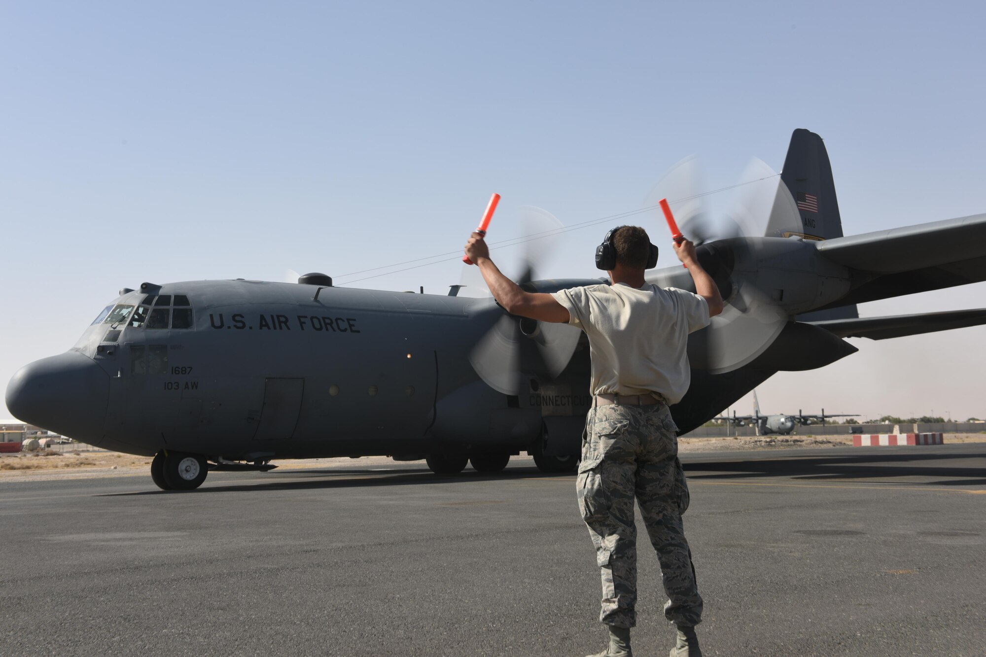 U.S. Air Force Academy Cadet Trey Griffin marshals a C-130 Hercules as it starts to taxi at an undisclosed location in Southwest Asia, June 27, 2017. The U.S. Air Force Academy cadets are deployed to the 386th Air Expeditionary Wing as part of the academy’s Operation Air Force program, which exposes cadets to a variety of career fields to aid them in their future career selections. (U.S. Air Force photo by Tech. Sgt. Jonathan Hehnly)