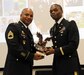 Capt. Eric Moton (right), chief, Finance Division for the U.S. Army Reserve’s 99th Regional Support Command, hands an award to Sgt. 1st Class Christopher Moore Nov. 5, 2016 during a retirement ceremony for Moore.  Moton earned his Ph.D. in business administration in 2016, joining a select group of Army Reserve Soldiers who have pursued higher education. Of all doctorates in the U.S. Army, 75 percent reside in the U.S. Army Reserve. Of all master’s degrees in the U.S. Army, 50 percent reside in the U.S. Army Reserve. Having such a highly educated force helps America’s Army Reserve remain the most capable, combat-ready and lethal federal reserve force in the history of the nation.