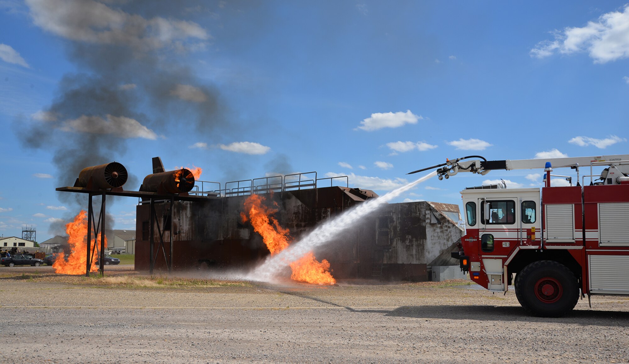 Host nation firefighters from Norfolk Fire and Rescue Service train with 100th Civil Engineer Squadron firefighters June 26, 2017, at the live-fire trainer on RAF Mildenhall, England. They visited the base to gain familiarization training on KC-135 Stratotankers, which increased effective communication and networking between the on and off base fire departments. A mutual aid agreement between RAF Mildenhall and the community means U.S. Air Force emergency responders are able to assist in emergencies off base when required, and local first responders can offer help on base. In order for each to be knowledgeable on the others’ areas of expertise, each fire department can offer different training to benefit both parties. (U.S. Air Force photo by Karen Abeyasekere)