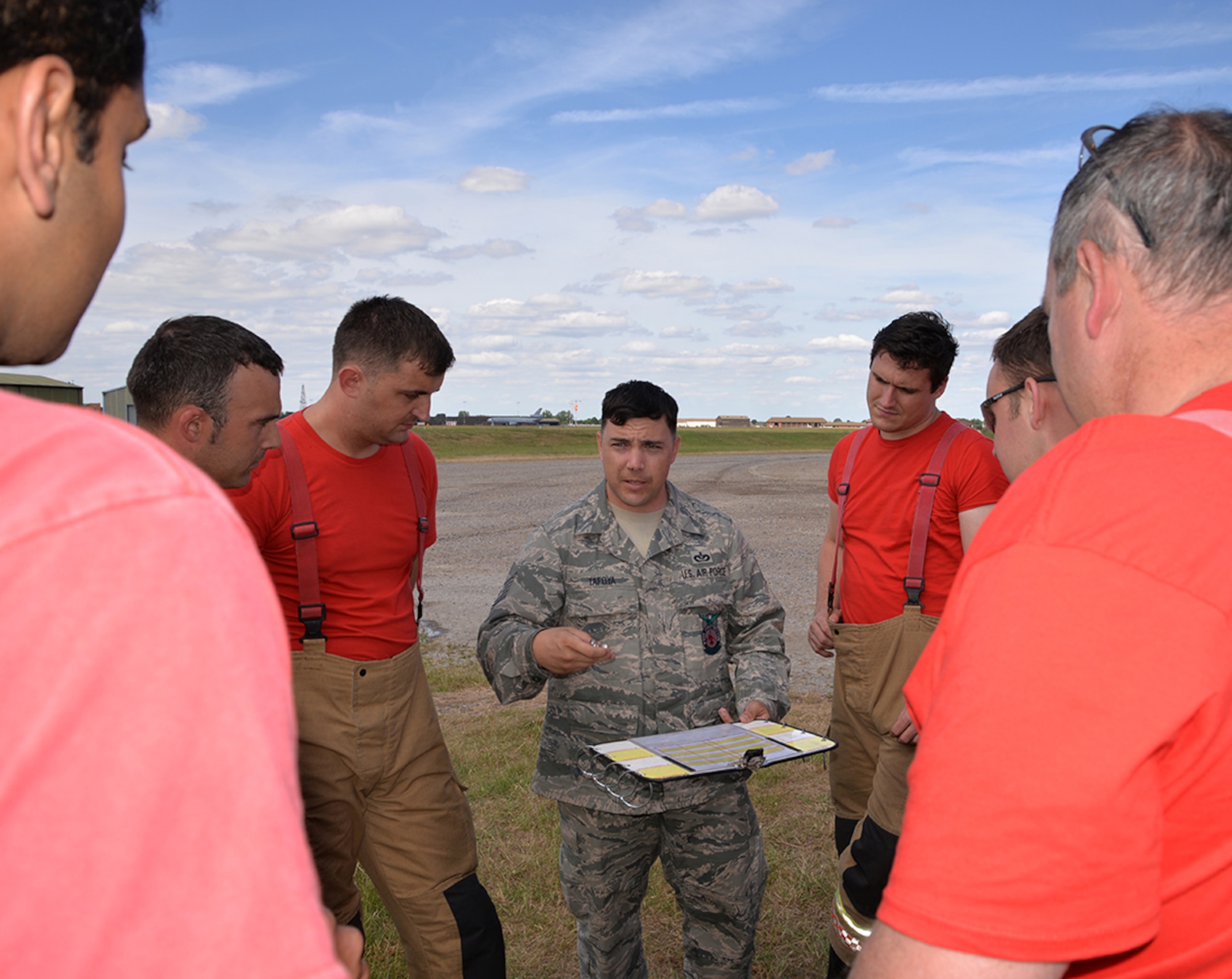 U.S. Air Force Tech. Sgt. Bryan Tafoya, 100th Civil Engineer Squadron Fire department crew chief, explains how the accountability system works for firefighters to host nation recruits from the Norfolk Fire and Rescue Service June 26, 2017, on RAF Mildenhall, England. The British firefighters visited the base to gain familiarization training on KC-135 Stratotankers, which increased effective communication and networking between the on and off base fire departments. (U.S. Air Force photo by Karen Abeyasekere)