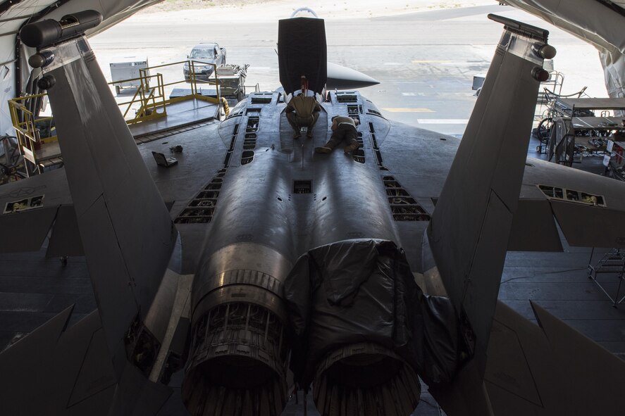 Airmen assigned to the 332nd Expeditionary Maintenance Squadron work on an F-15E Strike Eagle assigned to the 332nd Air Expeditionary Wing, June 16, 2017, in Southwest Asia. The maintainers separate the aircraft into five sections, allowing them to complete their inspection and maintenance in less time. (U.S. Air Force photo by Senior Airman Damon Kasberg)