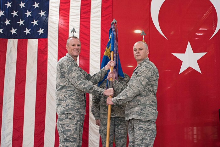 U.S. Air Force Col. Todd Stratton, 39th Mission Support Group commander, passes the guidon to Maj. Matthew Shaw, incoming 39th Logistics Readiness Squadron commander June 29, 2017, at Incirlik Air Base, Turkey. Stratton presided over the change of command. (U.S. Air Force photo by Airman 1st Class Kristan Campbell)
