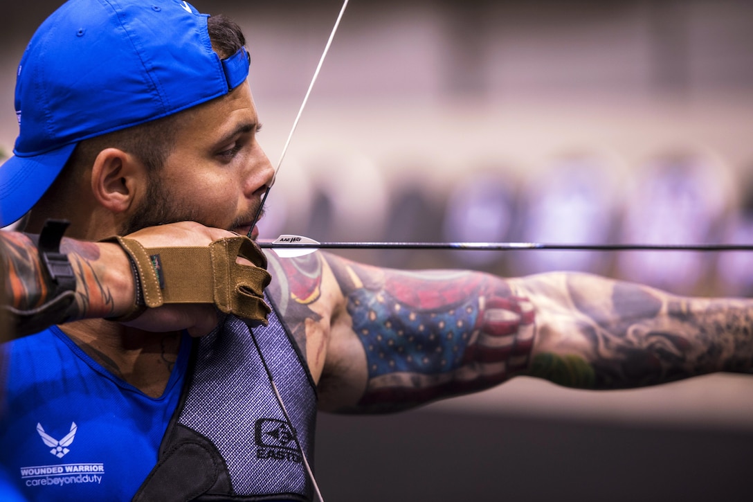 Air Force Senior Airman Rafael Morfinenciso, part of a medical administration troop, sets his sights on a target during archery team practice for the 2017 Department of Defense Warrior Games at McCormick Place-Lakeside Center in Chicago, June 30, 2017. Approximately 250 seriously wounded, ill and injured service members and veterans will participate in this year’s competition. Air Force photo by Staff Sgt. Keith James