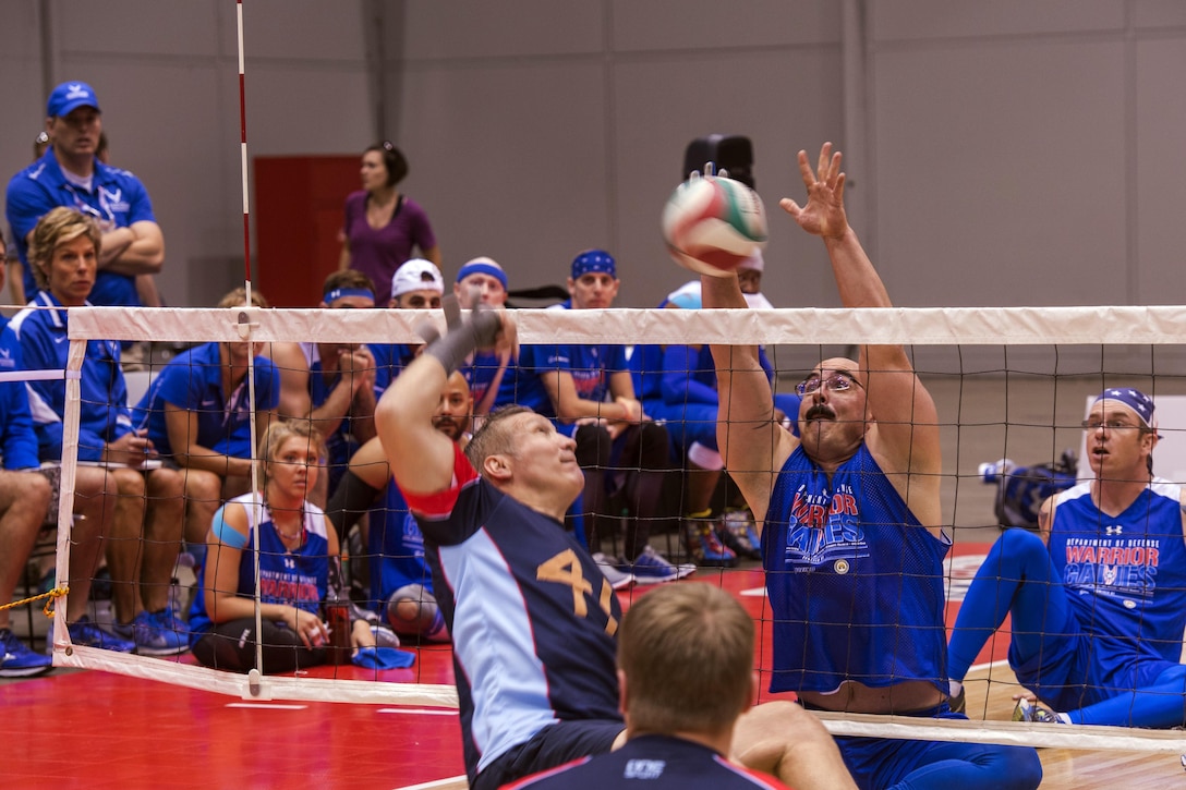 Air Force Staff Sgt. Jason Caswell goes for a block during a preliminary match against Team Australia in sitting volleyball during the 2017 Department of Defense Warrior Games at McCormick Place-Lakeside Center in Chicago, June 30, 2017. Adaptive sports provide unique opportunities for athletes to heal, regain confidence and purpose. Air Force photo by Staff Sgt. Keith James