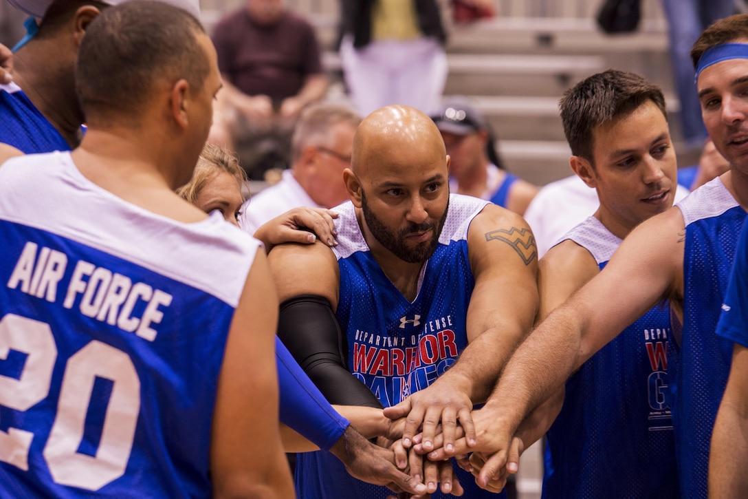 Air Force Master Sgt. Jarod Jones, an aircraft metals technician, leads Team Air Force’s sitting volleyball huddle after a timeout is called during a preliminary match at the 2017 Department of Defense Warrior Games at McCormick Place-Lakeside Center in Chicago, June 30, 2017. Air Force photo by Staff Sgt. Keith James