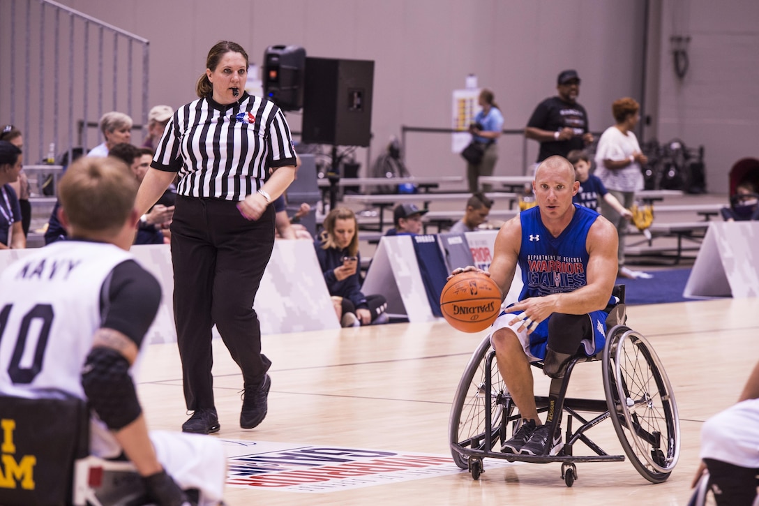 Air Force Tech. Sgt. Benjamin Seekell dribbles down the court during a preliminary game of wheelchair basketball during the 2017 Department of Defense Warrior Games at McCormick Place-Lakeside Center in Chicago, June 30, 2017. Air Force photo by Staff Sgt. Keith James