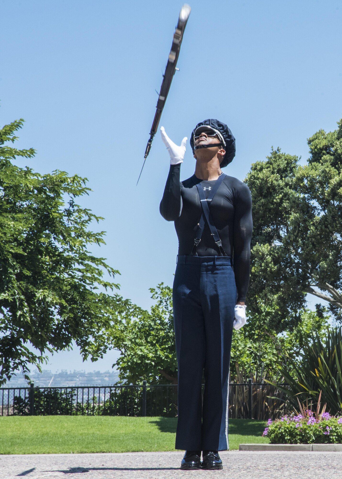 Airman 1st Class Tyrell Hall, U.S. Air Force Honor Guard Drill Team member, practices a rifle maneuver prior to a performance at Sea World in San Diego, Ca., June 27, 2017. To perform professionally choreographed sequences of weapon maneuvers, drill team members must attend an eight-week course as well as repeatedly practicing each routine. (U.S. Air Force photo by Senior Airman Jordyn Fetter)