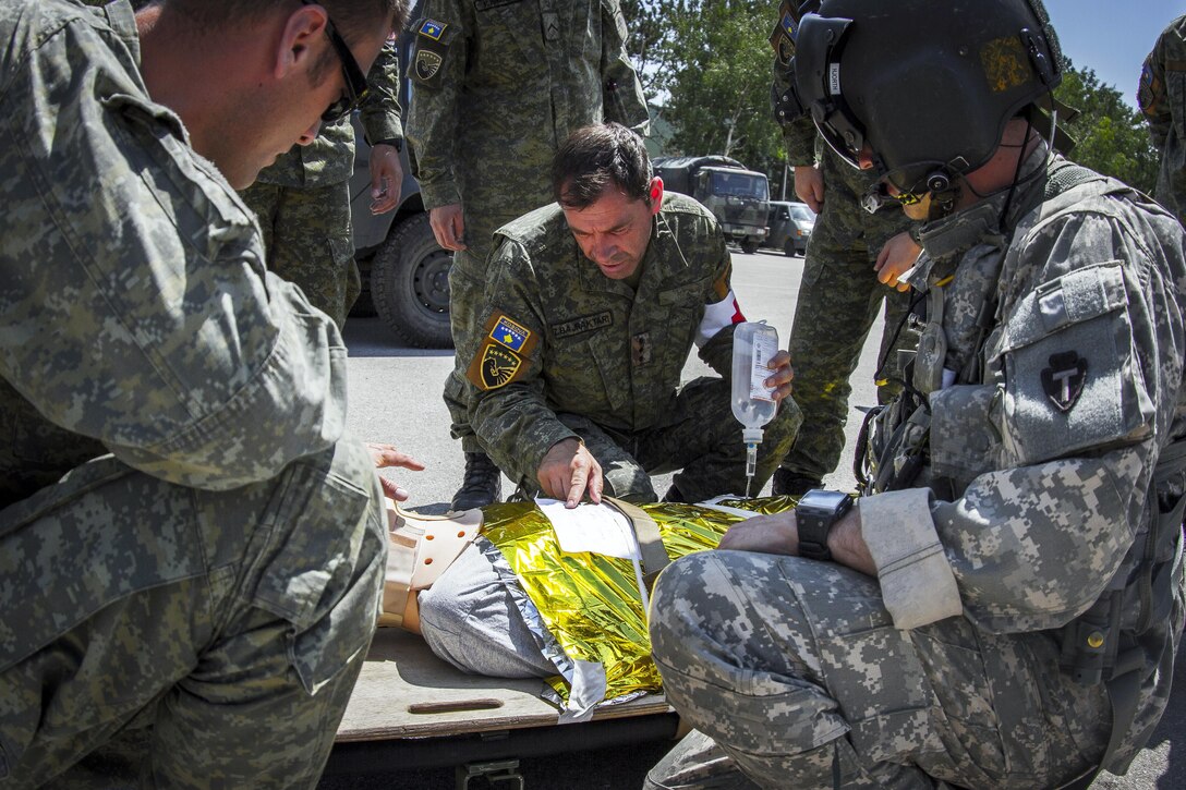 Members of the Kosovo Security Force and Army soldiers, assigned to Multinational Battle Group-East’s Southern Command Post, treat a casualty during medevac training in Pristina, Kosovo, June 28, 2017. The patients were evacuated from a village and transported to a make-shift hospital. Army photo by Spc. Adeline Witherspoon