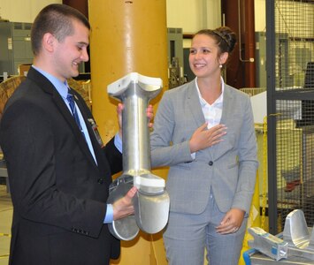 DAHLGREN, Va. (June 13, 2017) - A Science, Mathematics & Research for Transformation (SMART) Scholar holds a railgun test article during a briefing of the U.S. Navy's electromagnetic railgun prototype launcher. The Missile Defense Agency sponsored the college students who are among those pursuing a degree in, or closely related to, science, technology, engineering, and mathematics disciplines through the Department of Defense SMART Scholar program. Students selected for SMART Scholarships are offered internships and opportunities to pursue civilian careers in the federal government.