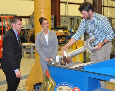 DAHLGREN, Va. (June 13, 2017) - A Navy railgun engineer explains the mechanics behind railgun test articles to Science, Mathematics & Research for Transformation (SMART) Scholars during a briefing of the U.S. Navy's electromagnetic railgun prototype launcher. The Missile Defense Agency sponsored the college students who are among those pursuing a degree in, or closely related to, science, technology, engineering, and mathematics disciplines through the Department of Defense SMART Scholar program. Students selected for SMART Scholarships are offered internships and opportunities to pursue civilian careers in the federal government.