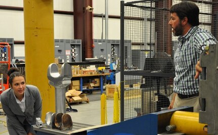 DAHLGREN, Va. (June 13, 2017) - A Science, Mathematics & Research for Transformation (SMART) Scholar peers down the barrel of the electromagnetic railgun prototype launcher at Naval Surface Warfare Center Dahlgren Division (NSWCDD). Navy scientists and engineers briefed the college students on electromagnetic launchers, hypervelocity projectiles, directed energy weapons, and chemical, biological, and radiological detection and defense technologies during their NSWCDD tour. The Missile Defense Agency sponsored the college students who are pursuing a degree in, or closely related to, science, technology, engineering, and mathematics disciplines through the Department of Defense SMART Scholar program. Students selected for SMART Scholarships are offered internships and opportunities to pursue civilian careers in the federal government.