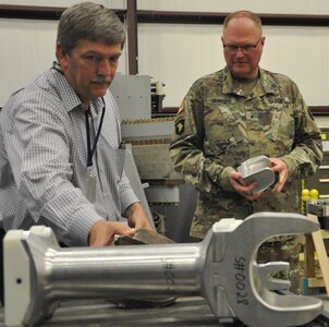 DAHLGREN, Va. (June 14, 2017) - Chester Petry, Electromagnetic Railgun lead systems engineer, briefs Army Brig. Gen. Randy McIntire, commandant of the Air Defense Artillery School, on electromagnetic railgun projectiles. McIntire, who is also the Chief of the Army's Air Defense Artillery, was briefed on Navy railgun and directed energy programs - including high energy lasers - during his tour at Naval Surface Warfare Center Dahlgren Division.  The Air Defense Artillery Center and School provides the Army and combatant commanders with a flexible, adaptive, and tailorable Air Defense Artillery force able to defeat the full range of threats across the spectrum of operations. It's operational mission is to provide fires to protect the force and selected geopolitical assets from aerial attack, missile attack and surveillance. (U.S. Navy photo/Released) 