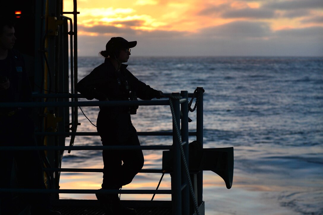 Navy Seaman Aisling Glover stands aft lookout watch on the fantail of the aircraft carrier USS Theodore Roosevelt the Pacific Ocean, June 27, 2017. Glover is a boatswain's mate. Navy photo by Petty Officer 3rd Class Alexander Perlman