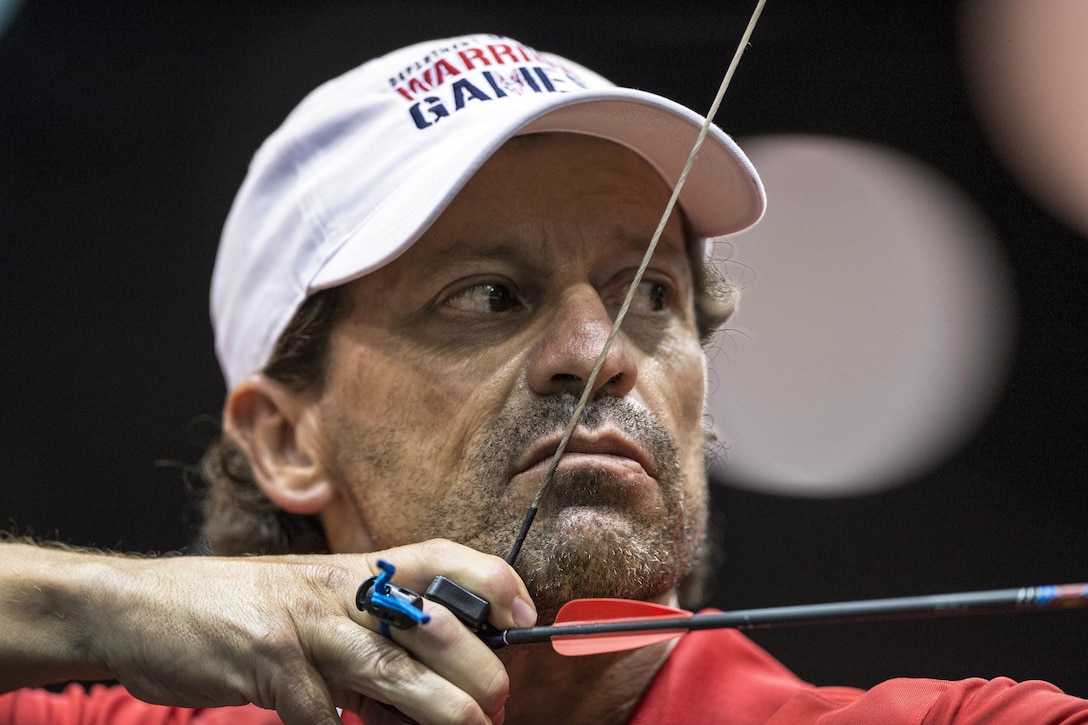 Marine Corps veteran Master Sgt. Mark Mann draws his bow during the 2017 Department of Defense Warrior Games archery competition in  Chicago, July 3, 2017. The annual event allows wounded, ill and injured service members and veterans to compete in Paralympic-style sports. DoD photo by EJ Hersom