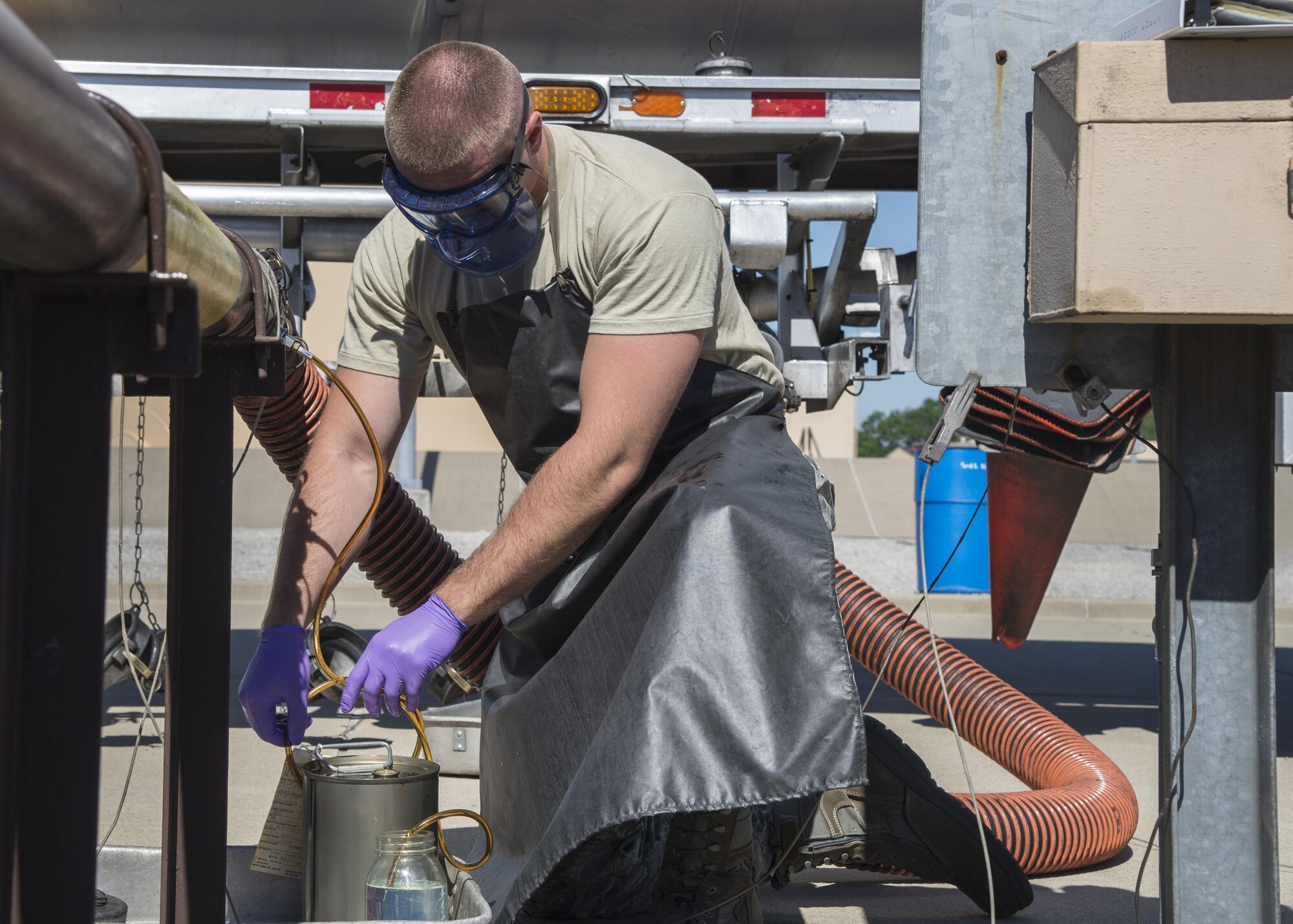 Senior Airman Ian Elder, 375th Logistics Readiness Squadron fuels laboratory technician, pulls a sample from a fuel truck June 14, 2017, Scott Air Force Base, Ill. The 375th LRS receives, stores and issues petroleum products purchased for use in Air Force vehicles, aircraft and support equipment. (U.S. Air Force photo by Senior Airman Melissa Estevez)
