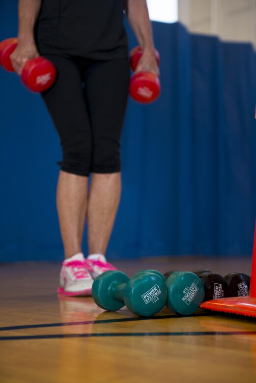 Retired Senior Master Sgt. Jeannie Morrison lifts weights during a Wellbeats class held at the fitness center, July 5, 2017, Niagara Falls Air Reserve Station, N.Y. Fitness classes are held throughout the week here, focusing on cardio and strength training. (U.S. Air Force photo by Tech. Sgt. Stephanie Sawyer) 

