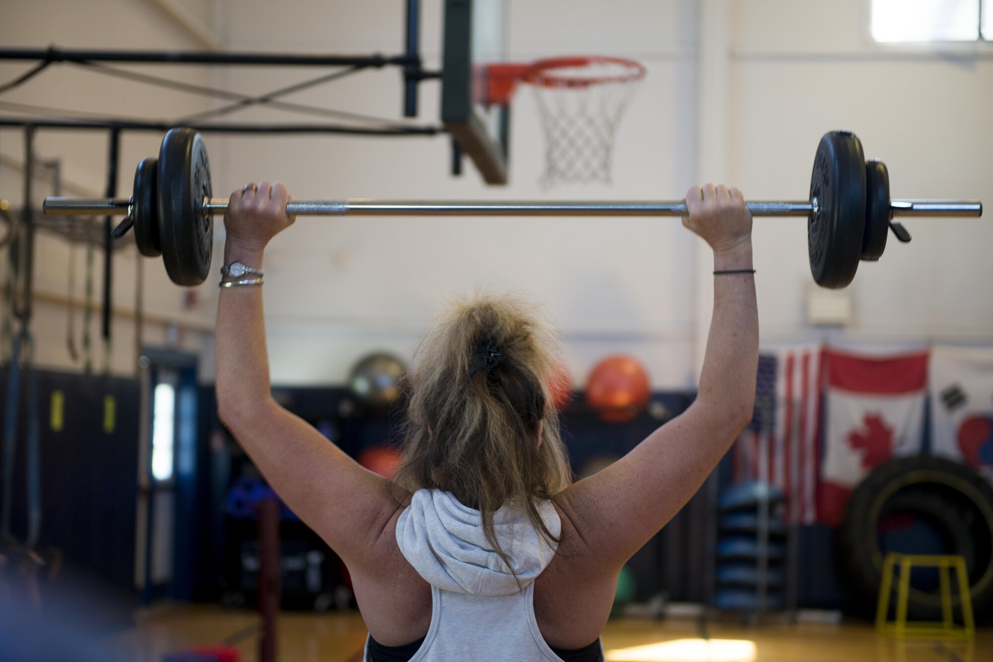 Gracie Poitras lifts weights above her head during a Wellbeats class held at the fitness center, July 5, 2017, Niagara Falls Air Reserve Station, N.Y. Fitness classes are held throughout the week here, focusing on cardio and strength training. (U.S. Air Force photo by Tech. Sgt. Stephanie Sawyer) 
