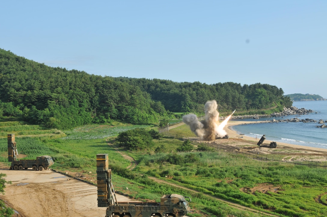 An M270 Multiple Launch Rocket System from 1st Battalion, 18th Field Artillery Regiment, 210th Field Artillery Brigade, 2nd Republic of Korea/United States Combined Division, fires an MGM-140 Army Tactical Missile into the Sea of Japan, July 5, 2017. In the foreground, two mobile carriers prepare to launch South Korean Hyunmoo II missiles. The missile launches demonstrated the combined deep strike capabilities which allow the South Korean-U.S. alliance to neutralize hostile threats and aggression against South Korea, the U.S. and other allies. Army photo