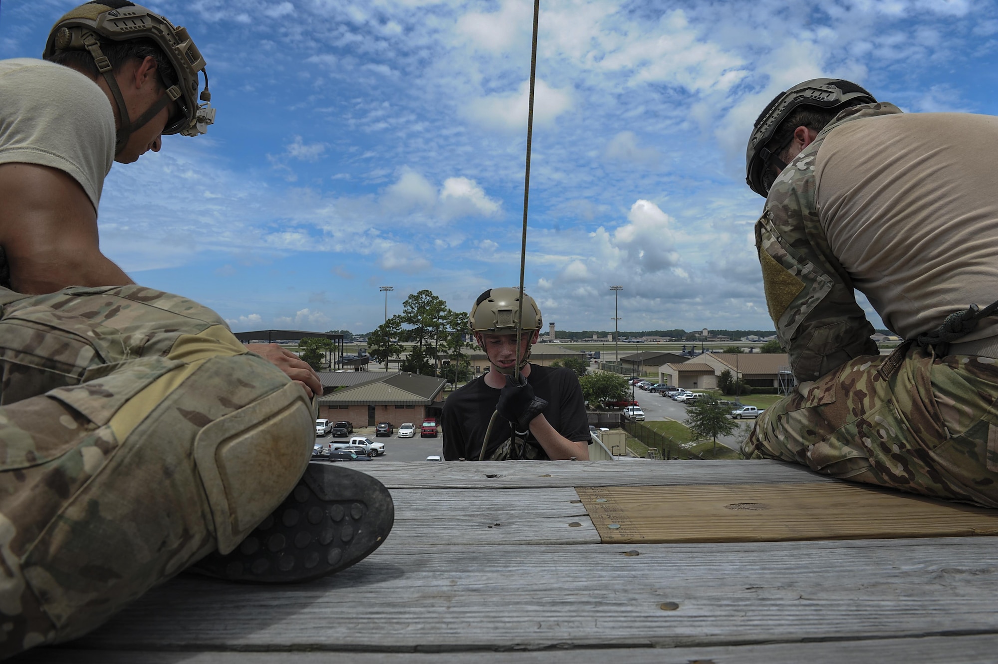 A Junior ROTC cadet rappels down a tower during Summer Leadership School at Hurlburt Field, Fla., June 28, 2017. More than 50 cadets from five local high schools rappelled down a 60-foot wall to experience rescue and infiltration techniques under the close supervision of Special Tactics Airmen. (U.S. Air Force photo by Airman 1st Class Rachel Yates)