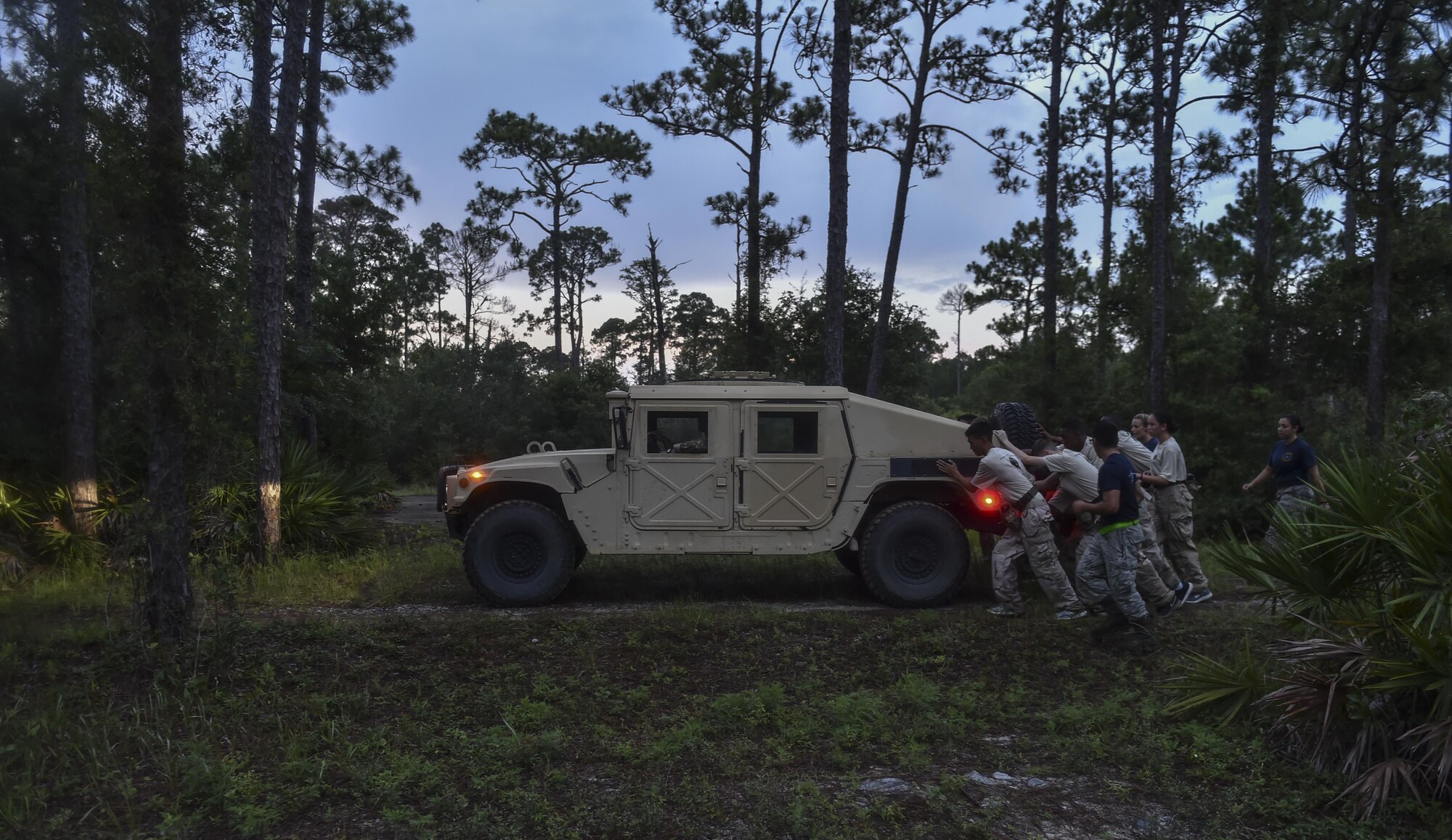 Junior ROTC cadets push a humvee through the woods during a Monster Mash for Summer Leadership School at Hurlburt Field, Fla., June 30, 2017. Monster Mash is a long-standing Special Tactics training tradition, an event where special operators will complete timed scenarios at different stations of core mission training. (U.S. Air Force photo by Senior Airman Ryan Conroy 