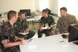 From left to right, 1st Lt. Mark Vadasz, Hungarian Civil Military Cooperation (CIMIC), Capt. Philip Hristov, Bulgarian CIMIC, 1st Lt. Musat Cosmin, Romanian CIMIC, with Capt. Anthony W. Smith, lead exercise planner from 361st Civil Affairs Brigade, sit together to plan future civil engagements for Saber Guardian 17 (SG17) in Novo Selo Training Area, Bulgaria on July 4, 2017. 361st CA BDE is responsible for conducting civil engagements and activities to promote transparency and the relationship between U.S. forces, civilian authorities and civilian populations during SG17 (U.S. Army photo by Sgt. Charity Boedeker, 361st CA BDE Public Affairs).