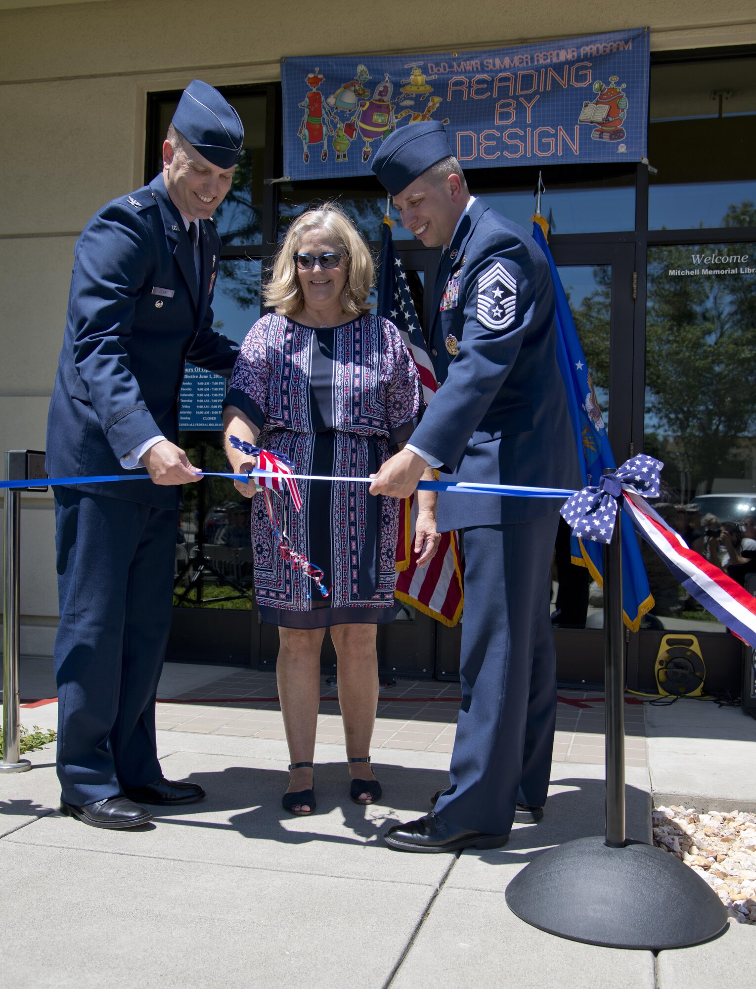 Col. Matthew Leard, 60th Air Mobility Wing vice commander, Jeannette Tross, niece of Maj. Ardis Crumpton, and Chief Master Sgt. Steve Nichols, 60th Air Mobility Wing command chief, cut the ribbon at the Mitchell Memorial Library rededication ceremony at Travis Air Force Base, Calif., June 28, 2017. The rededication celebrated the 60th anniversary of when the library was named after Lt. Col. Kirk Mitchell, aircraft commander on a mission from Wake Island to Yokota Air Base, Japan. The aircraft was lost 160 miles off the coast of Japan and never found. The 10-personnel crew and 57 passengers all died in the crash. (U.S. Air Force photo/Staff Sgt. Nicole Leidholm)