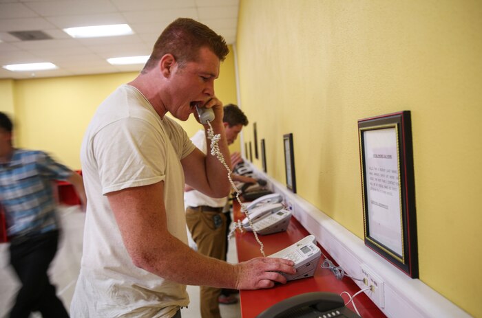Recruits from Kilo Company, 3rd Recruit Training Battalion, make their phone calls home, reading only what is printed on the script in front of them, during receiving at Marine Corps Recruit Depot San Diego, May 22. Recruits will not be able to make another phone call until the end of recruit training. Annually, more than 17,000 males recruited from the Western Recruiting Region are trained at MCRD San Diego. Kilo Company is scheduled to graduate Aug. 18.