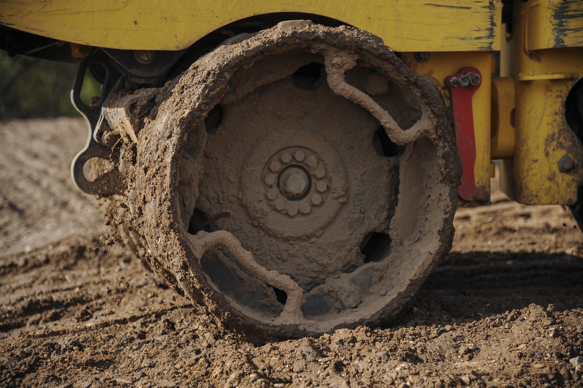 A sheepsfoot roller flattens dirt at Davis-Monthan Air Force Base, Ariz., June 8, 2017. The 355th Civil Engineer Squadron pavements and equipment shop used approximately 2,500 tons of dirt to help reconstruct Atterbury Wash, a natural creek on the installation, in preparation for monsoon season.  (U.S. Air Force photo by Senior Airman Mya M. Crosby)