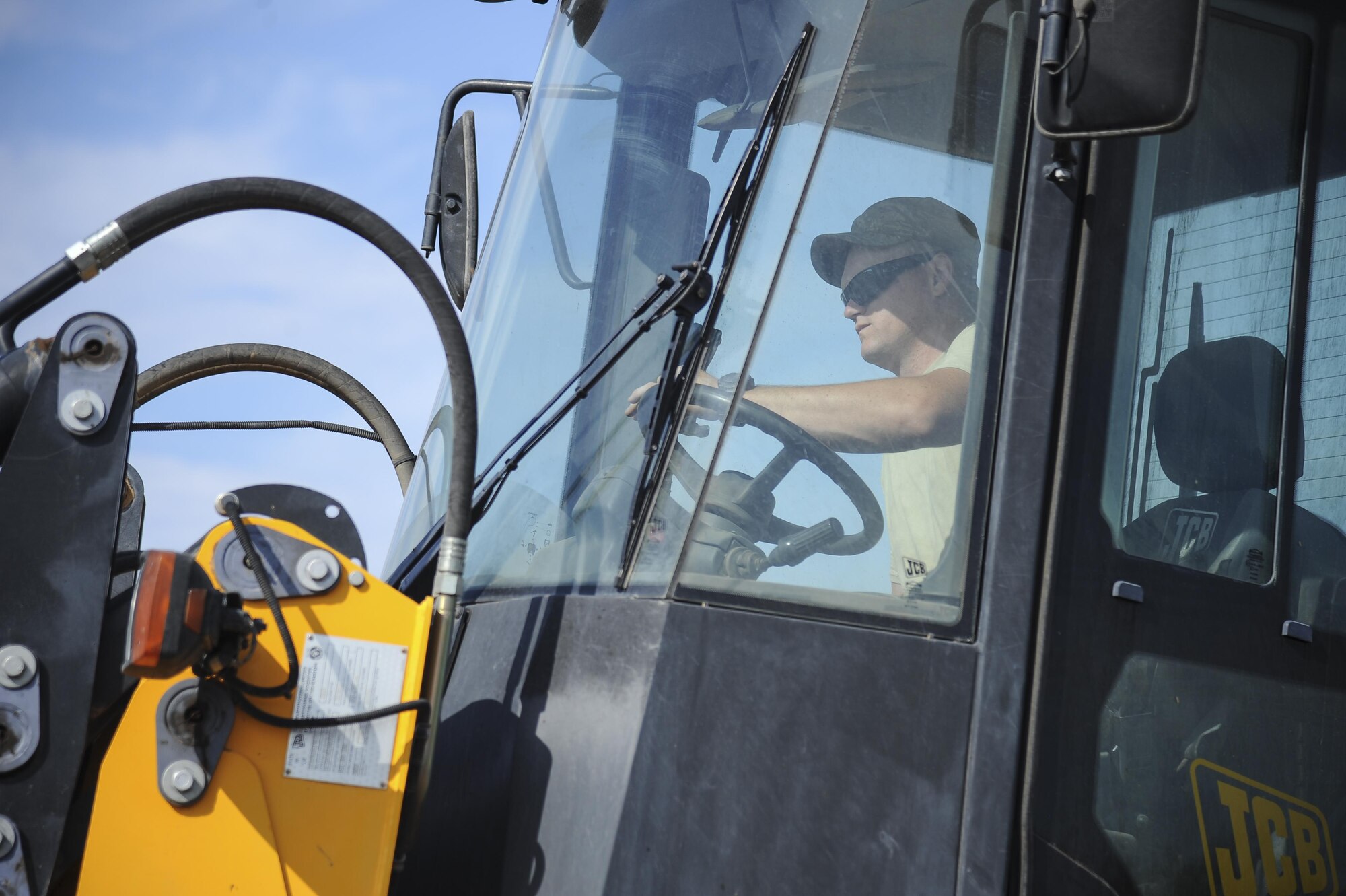 U.S. Air Force Staff Sgt. Chad McCay, 355th Civil Engineer Squadron pavements and equipment craftsman, utilizes a front-end roller at Davis-Monthan Air Force Base, Ariz., June 8, 2017. The pavements and equipment Airmen, also known as the Dirt Boyz, perform other tasks around the installation such as airfield sweeping, repair and maintenance. (U.S. Air Force photo by Senior Airman Mya M. Crosby)