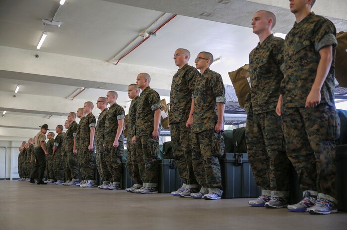 Recruits from Kilo Company, 3rd Recruit Training Battalion, wait for instruction during pick up at Marine Corps Recruit Depot San Diego, May 26. After spending the first week conducting in-processing, recruits marched to their new squad bay where their drill instructors introduced themselves, recited the Drill Instructor Creed and began carrying out the mission of transforming civilians into United States Marines. Annually, more than 17,000 males recruited from the Western Recruiting Region are trained at MCRD San Diego. Kilo Company is scheduled to graduate Aug. 18.