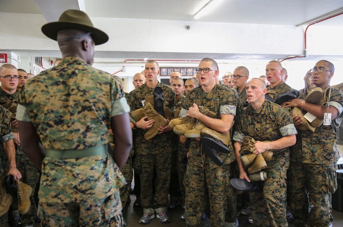 Recruits from Kilo Company, 3rd Recruit Training Battalion, listen to their drill instructor’s orders during pick up at Marine Corps Recruit Depot San Diego, May 26. During the first few hours the drill instructors are with their new recruits they will teach them the in-house procedures they must follow for the rest of recruit training. Annually, more than 17,000 males recruited from the Western Recruiting Region are trained at MCRD San Diego. Kilo Company is scheduled to graduate Aug. 18.