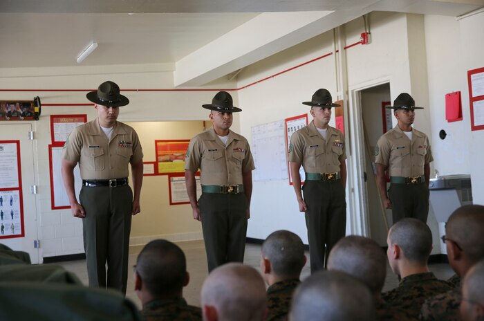 Drill instructors with Charlie Company, 1st Recruit Training Battalion, are introduced to their new recruits before reciting the Drill Instructor Creed during pick up at Marine Corps Recruit Depot San Diego, June 9. Upon completing the creed, the drill instructors begin their mission of transforming their recruits into Marines. Annually, more than 17,000 males recruited from the Western Recruiting Region are trained at MCRD San Diego. Charlie Company is scheduled to graduate Sept. 1.