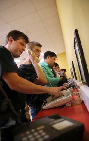 Recruits from Lima Company, 3rd Recruit Training Battalion, make their phone calls home, reading only what is printed on the script in front of them, during receiving at Marine Corps Recruit Depot San Diego, June 19. Recruits will not be able to make another phone call until the end of recruit training. Annually, more than 17,000 males recruited from the Western Recruiting Region are trained at MCRD San Diego. Lima Company is scheduled to graduate Sept. 15.