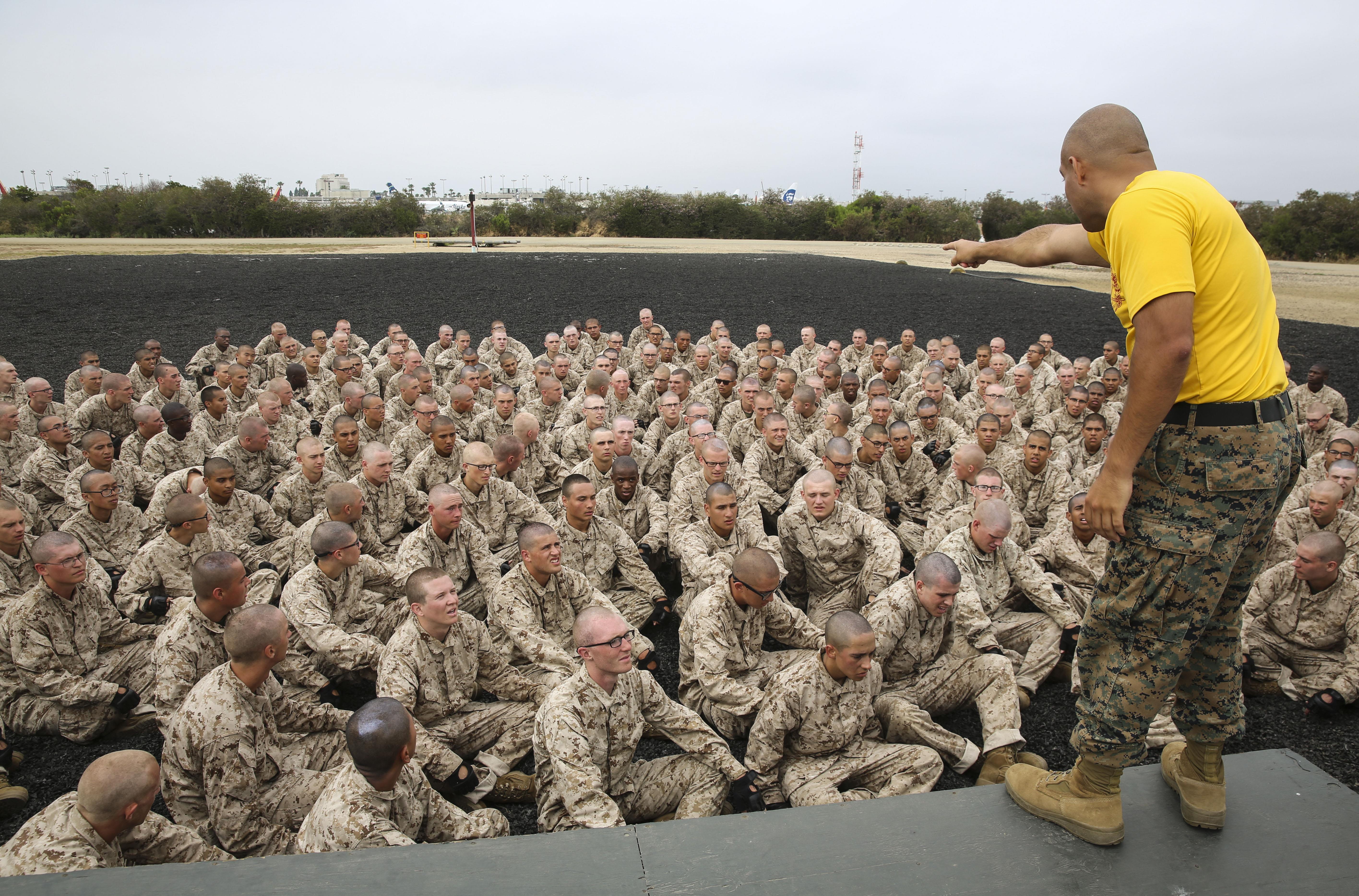 Recruits of Fox Company, 2nd Recruit Training Battalion, are briefed before a Marine Corps Martial Arts Program session at Marine Corps Recruit Depot San Diego, June 23. At the start of a MCMAP session, instructors demonstrate the techniques the recruits will execute. Annually, more than 17,000 males recruited from the Western Recruiting Region are trained at MCRD San Diego. Fox Company is scheduled to graduate Sept. 8.