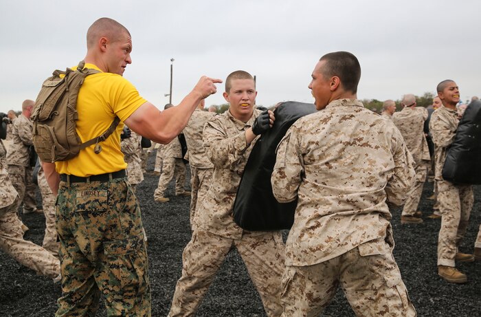 A drill instructor with Fox Company, 2nd Recruit Training Battalion, corrects a recruit during a Marine Corps Martial Arts Program session at Marine Corps Recruit Depot San Diego, June 23. Drill instructors walked around during the training process to make sure each recruit was executing the technique correctly. Recruits can use this time to ask drill instructors questions if they are unsure of how to properly conduct the move. Annually, more than 17,000 males recruited from the Western Recruiting Region are trained at MCRD San Diego. Fox Company is scheduled to graduate Sept. 8.