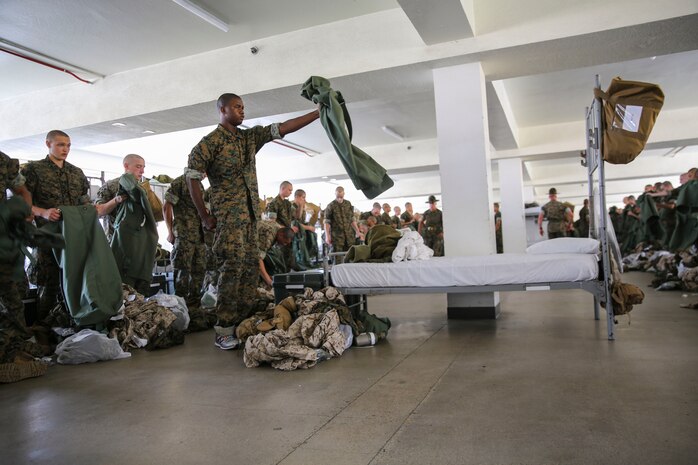 Recruits from Lima Company, 3rd Recruit Training Battalion, hold out their sea bags during pick up at Marine Corps Recruit Depot San Diego, June 23. Drill instructors ensure that the recruits fill each bag with the appropriate items and that extra gear is emptied into the recruit’s footlocker. Annually, more than 17,000 males recruited from the Western Recruiting Region are trained at MCRD San Diego. Lima Company is scheduled to graduate Sept. 15.