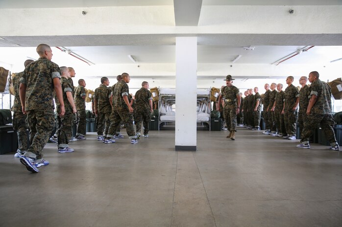 A drill instructor from Lima Company, 3rd Recruit Training Battalion, instructs recruits to freeze during pick up at Marine Corps Recruit Depot San Diego, June 23. During the first few hours the drill instructors are with their new recruits they will teach them the in-house procedures they must follow for the rest of recruit training. Annually, more than 17,000 males recruited from the Western Recruiting Region are trained at MCRD San Diego. Lima Company is scheduled to graduate Sept. 15.