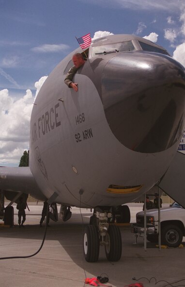 Captain Kevin Rainey, 96th Air Refuling Squadron, 92nd Air Refuling Wing co-pilot, displays an American flag after returning to Fairchild Air Force Base, Washington. The first groups of 92nd Air Refueling Wing personnel returned home from deployments supporting Operation ALLIED FORCE. Twenty-four aircraft and more than 660 personnel were deployed to seven different locations. (Courtesy Photo)