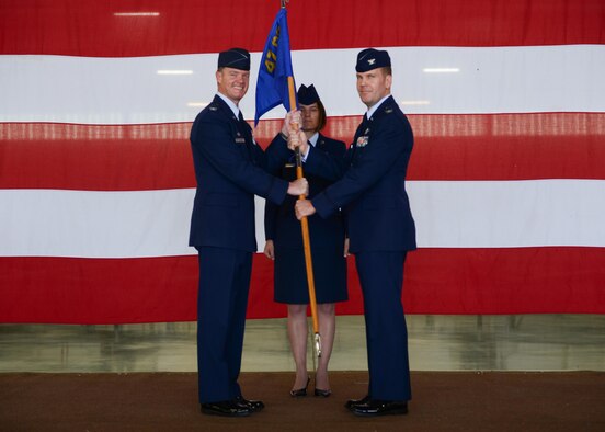 U.S. Air Force Col. Thomas Shank, former 47th Flying Training Wing commander (left), passes the 47th Operations Group guideon to Col. Robert Pekarek, 47th Operations Group commander at Laughlin Air Force Base, Tx., June 22, 2017. The passing of the guideon symbolizes the ceremonious assumption of responsibility and command from one party to another. (U.S. Air Force photo/Airman 1st Class Benjamin N. Valmoja)