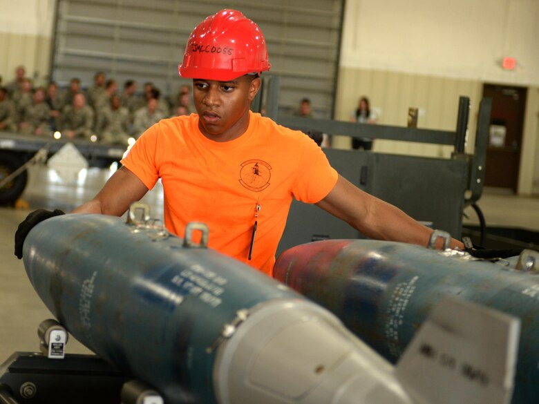 Airman 1st Class Nathaniel Porter, a conventional maintenance crew member from the 28th Munitions Squadron, moves dummy ordinance down an assembly line to be loaded on a delivery truck on Ellsworth Air Force Base, S.D. June 26, 2017. Airmen from the 28th MUNS were able to finish assembling all the dummy bombs in approximately 26 minutes in a timed trial to see how well they could work together under pressure. (U.S. Air Force photo by Airman 1st Class Thomas Karol)