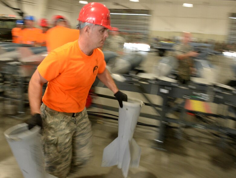 Senior Airman Daniel Deweese, a conventional maintenance crew member from the 28th Munitions Squadron, prepares to apply a tail kit to a dummy bomb on Ellsworth Air Force Base, S.D. June 26, 2017. Airmen from the 28th MUNS participated in a dummy bomb build as part of the annual Air Force Global Strike Command challenge which is designed to showcase the world’s premier bomber and intercontinental ballistic missile force. 