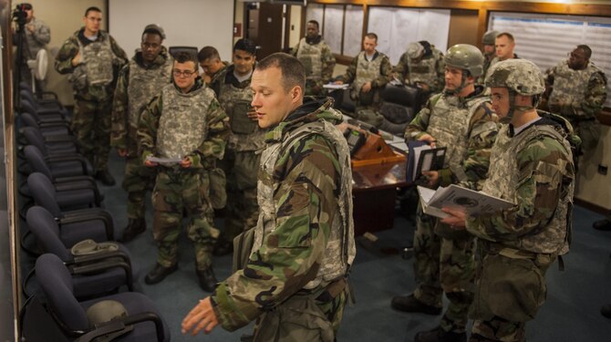 U.S. Air Force Maj. Peeter Pleake-Tamm, 8th Civil Engineering Squadron Airfield Damage Repair officer in charge, conducts a briefing during a base recovery exercise June 29, 2017, at Kunsan Air Base, Republic of Korea. Civil Engineers mapped out simulated battle damage to the runway and plotted the best course of action to fix the damage in the least time possible. (U.S. Air Force photo by Senior Airman Colville McFee/Released)