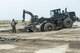 U.S. Air Force Tech. Sgt. Freeman Gleaves, 8th Civil Engineering Squadron pavement and construction craftsman, directs how much gravel to pour into a simulated runway crater during an exercise June 29, 2017, at Kunsan Air Base, Republic of Korea. The airfield damage repair exercise gave Airmen an opportunity to test their ability to map runway damage and plot the best course of action to fix that damage in the shortest possible time. (U.S. Air Force photo by Senior Airman Colville McFee/Released)