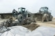 Two U.S. Air Force loaders assigned to the 8th Civil Engineering Squadron unload rocks into a crater June 29, 2017, while participating in an exercise at Kunsan Air Base, Republic of Korea. Airmen assigned to the CES were tasked with repairing a damaged portion of the runway while participating in an airfield damage repair exercise. (U.S. Air Force photo by Senior Airman Colville McFee/Released)