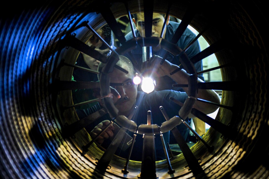 Sailors inspect a jet engine aboard the USS Nimitz in the Pacific Ocean, June 29, 2017. The aircraft carrier is underway in the U.S. 7th Fleet area of operations. Navy photo by Petty Officer 3rd Class Leon Wong