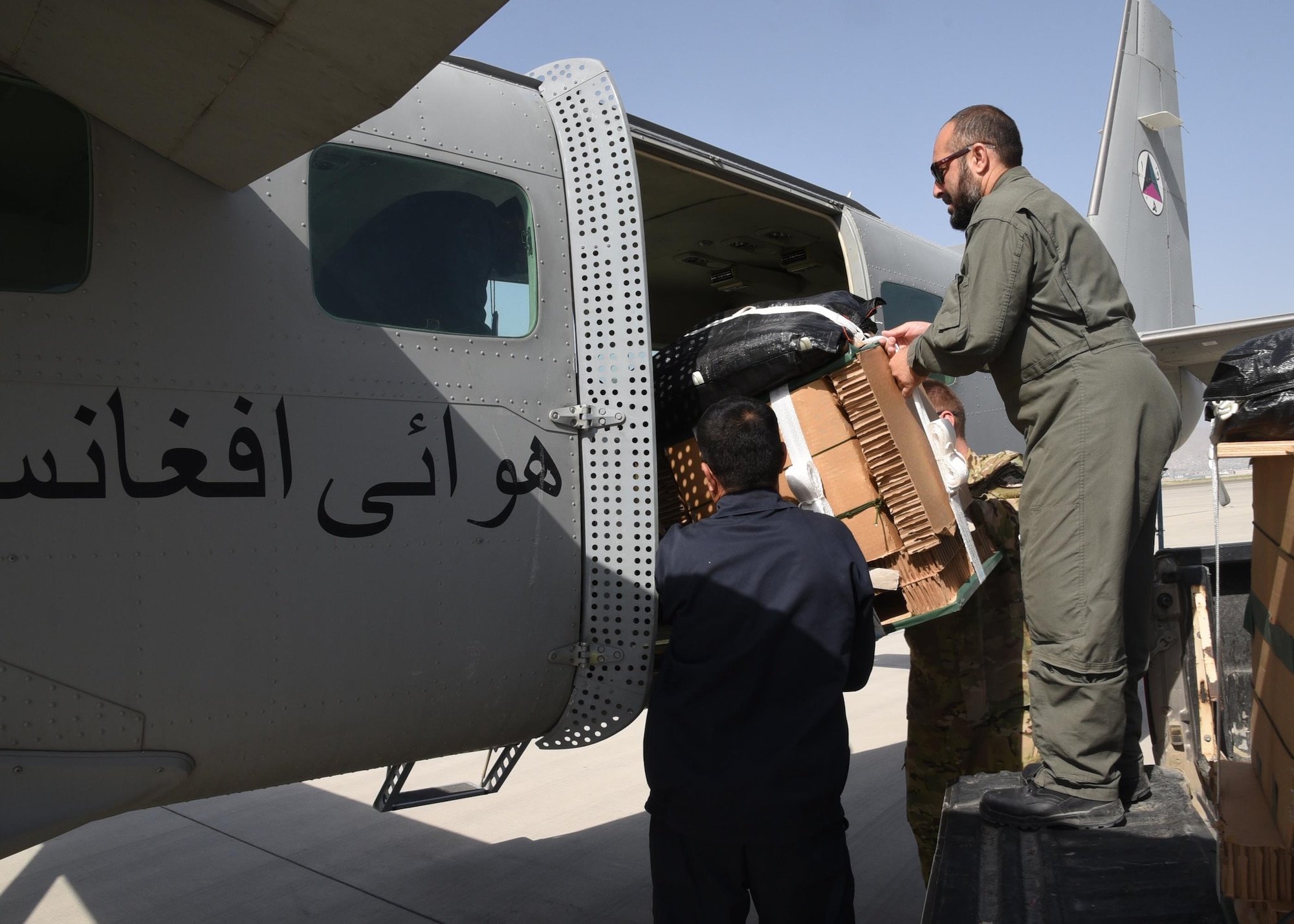 An Afghan Air Force C-208 crew loads a resupply pallet for delivery over Southeast, Afghanistan, on June 28, 2017. This was the first operational airdrop performed by AAF aircrew. The AAF successfully delivered 800 pounds of supplies to Afghan Border Police at their coordinated drop zone. (U.S. Air Force photo by Tech. Sgt. Veronica Pierce)