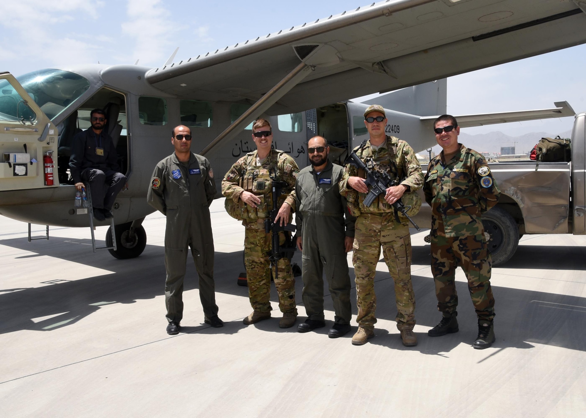 Afghan Air Force C-208 aircrew and maintenance members pose for a photo with Train, Advise, Assist Command-Air, 538th Air Expeditionary Advisory Squadron C-208 advisors, after delivering supplies to Afghan National Defense Security Forces ground troops on June 28, 2017. This was the first operational airdrop performed by AAF aircrew. The AAF successfully delivered 800 pounds of supplies to Afghan Border Police at their coordinated drop zone. (U.S. Air Force photo by Tech. Sgt. Veronica Pierce)